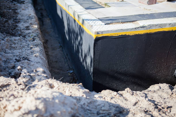 Professional Basement Waterproofing technician working in Brentwood, NY